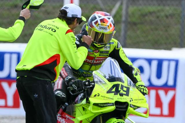 Team Pertamina Enduro VR46 Racing Team's Fabio Di Giannantonio celebrates with Valentino Rossi (L) after the 2026 Catalunya Moto GP Grand Prix at the Catalunya racetrack in Montmelo, near Barcelona, on May 17, 2026. (Photo by JOSE JORDAN / AFP)