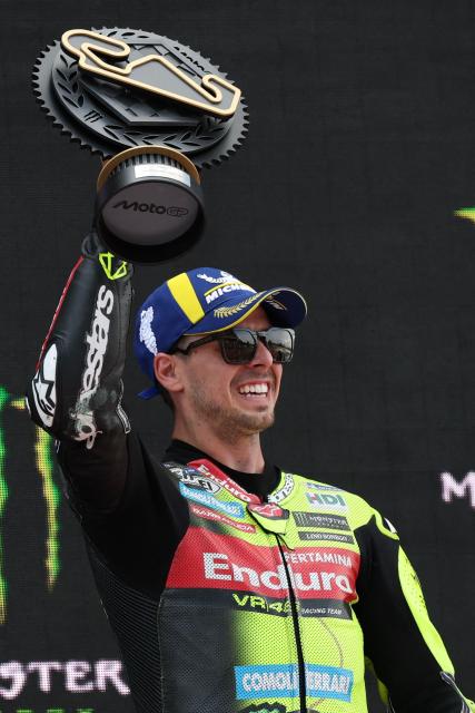 Team Pertamina Enduro VR46 Racing Team's Fabio Di Giannantonio celebrates on the podium after winning the 2026 Catalunya Moto GP Grand Prix at the Catalunya racetrack in Montmelo, near Barcelona, on May 17, 2026. (Photo by Lluis GENE / AFP)