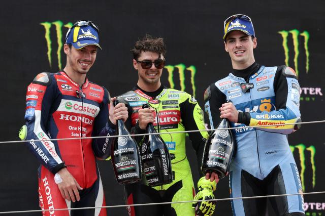 First placed Team Pertamina Enduro VR46 Racing Team's Fabio Di Giannantonio (C) celebrates on the podium with second placed Team Repsol Honda Team's Joan Mir (L) and third placed eam Gresini Racing MotoGP's Fermin Aldeguer after the 2026 Catalunya Moto GP Grand Prix at the Catalunya racetrack in Montmelo, near Barcelona, on May 17, 2026. (Photo by Lluis GENE / AFP)