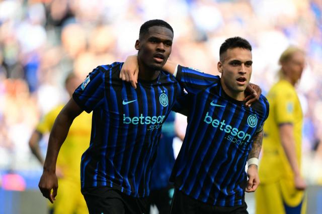 Inter Milan's French forward #14 Ange-Yoan Bonny celebrates his team's first goal with Inter Milan's Argentinian forward #10 Lautaro Martinez during the Italian Serie A football match between Inter Milan and Hellas Verona at San Siro stadium in Milan, on May 17, 2026. (Photo by Marco BERTORELLO / AFP)