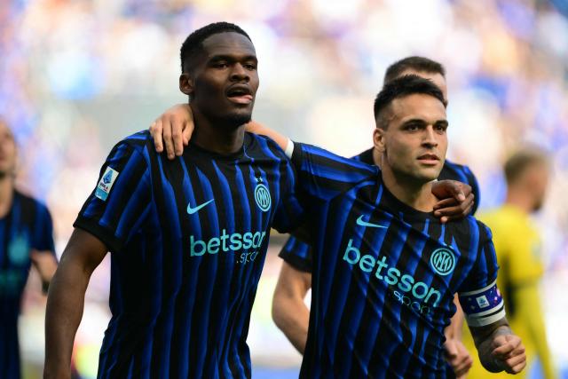 Inter Milan's French forward #14 Ange-Yoan Bonny celebrates his team's first goal with Inter Milan's Argentinian forward #10 Lautaro Martinez during the Italian Serie A football match between Inter Milan and Hellas Verona at San Siro stadium in Milan, on May 17, 2026. (Photo by Marco BERTORELLO / AFP)