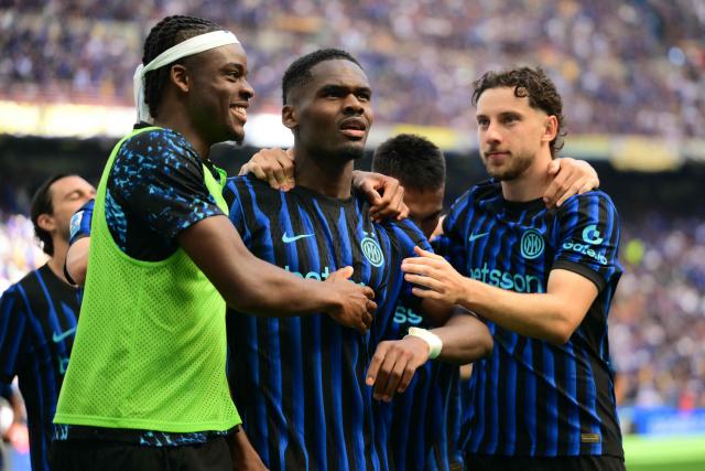 Inter Milan's French forward #14 Ange-Yoan Bonny (C) celebrates his team's first goal with teammates during the Italian Serie A football match between Inter Milan and Hellas Verona at San Siro stadium in Milan, on May 17, 2026. (Photo by Marco BERTORELLO / AFP)