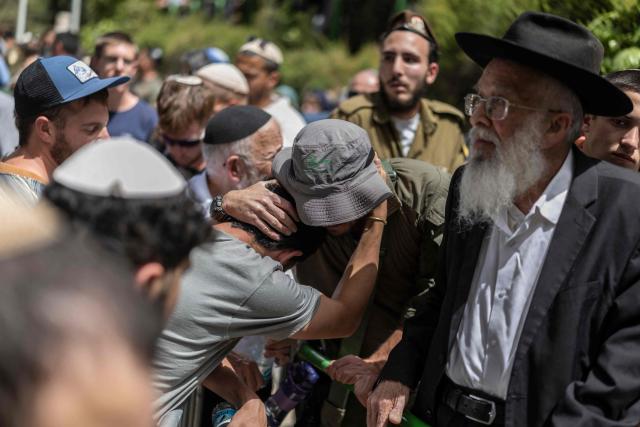 Family and friends mourn Israeli army Captain Maoz Israel Recanati, who was killed in combat in Lebanon, during the funeral in Jerusalem on May 17, 2026. Israel's military said on May 16 that Recanati died in combat in southern Lebanon, without providing additional information, bringing its losses to 21 personnel since the war with Hezbollah began in early March. Since the war began, 20 Israeli soldiers and one civilian contractor have been killed. (Photo by ilia YEFIMOVICH / AFP)