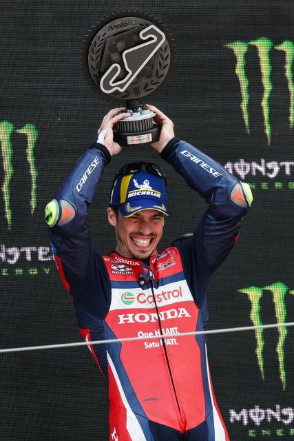 Team Repsol Honda Team's Joan Mir celebrates on the podium after finishing in second place at the 2026 Catalunya Moto GP Grand Prix at the Catalunya racetrack in Montmelo, near Barcelona, on May 17, 2026. (Photo by Lluis GENE / AFP)