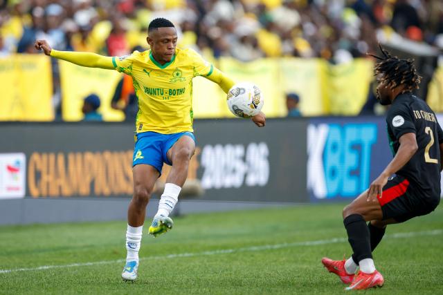 Sundowns' South African midfielder #16 Kutlwano Letlhaku controls the ball away from AS FAR's Angolan defender #2 To Carneiro during the CAF Champions League final first leg football match between Mamelodi Sundowns and AS FAR (Association Sportive des Forces Armees Royales - Royal Army Club) at Loftus Versfeld Stadium in Pretoria on May 17, 2026. (Photo by Phill Magakoe / AFP)