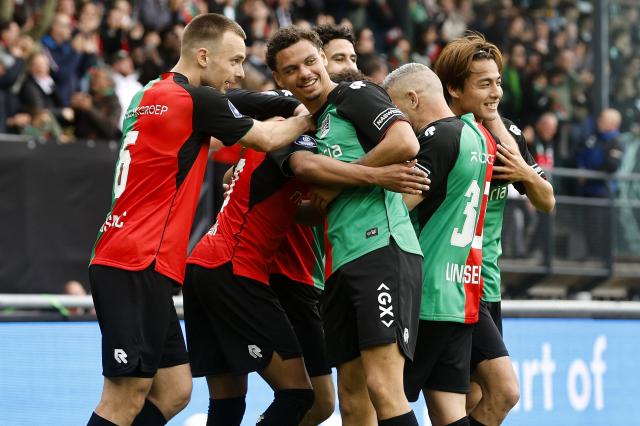 NEC Nijmegen's Croatian midfielder #6 Darko Nejasmic (L), NEC Nijmegen's Curacaoan defender #24 Deveron Fonville (C) and NEC Nijmegen's Japanese midfielder #23 Kodai Sano (R) celebrate the team's second goal during the Dutch Eredivisie football match between NEC Nijmegen and Go Ahead Eagles at Goffert stadium in Nijmegen on May 17, 2026. (Photo by Bart Stoutjesdijk / ANP / AFP) / Netherlands OUT
