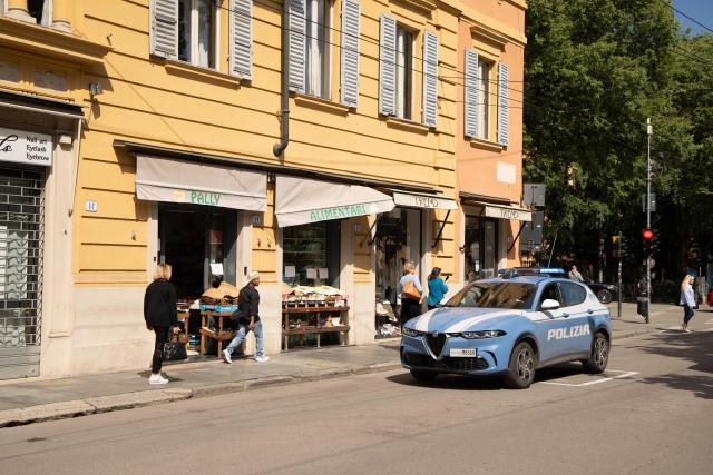 A Police car patrols in the center of Modena a day after a man drove his car into pedestrians injuring eight people, on May 17, 2026. Italian Prime Minister Giorgia Meloni visited people wounded by a driver with a history of mental health problems who ran over several pedestrians in the center of Modena, Northern Italy. The driver, a 31-year-old Italian man of Moroccan heritage, hit several people before crashing into a shop window, colliding head-on with a woman. (Photo by Federico SCOPPA / AFP)