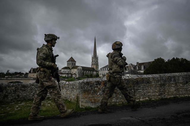 French Foreign Legion paratroopers from the 2nd Foreign Parachute Regiment (2e REP) patrol a bridge over the Gartempe river with the abbey of Saint-Savin-sur-Gartempe in the background during a bridge defence exercise in Saint-Savin, south-western France, on May 17, 2026. The exercise, running from May 11 to 20 across Nouvelle-Aquitaine and Centre-Val de Loire, tests short-notice redeployment and interoperability between air and ground components  capabilities central to France's contribution to NATO rapid-reaction forces. (Photo by Philippe LOPEZ / AFP)
