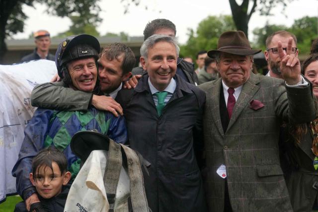 (From L) French jockey Johnny Charron, French owner Xavier Papot and French horse trainer Guillaume Macaire celebrate after Charron, riding "Sel Jem" won the 148th edition of the 'Grand Steeple-Chase de Paris' steeplechase horse race at the Auteuil Hippodrome in Paris on May 17, 2026. (Photo by Dimitar DILKOFF / AFP)