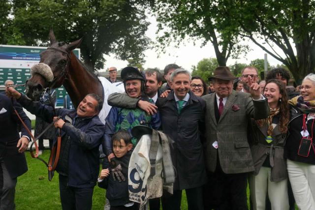 (From 2nd L) French jockey Johnny Charron, French owner Xavier Papot and French horse trainer Guillaume Macaire celebrate after Charron, riding "Sel Jem" won the 148th edition of the 'Grand Steeple-Chase de Paris' steeplechase horse race at the Auteuil Hippodrome in Paris on May 17, 2026. (Photo by Dimitar DILKOFF / AFP)