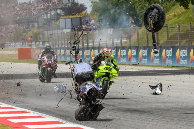The motorcycle of Team Gresini Racing MotoGP's Alex Marquez tumbles and breaks apart in front of Team Pertamina Enduro VR46 Racing Team's Fabio Di Giannantonio after Marquez crashed during the 2026 Catalunya Moto GP Grand Prix at the Catalunya racetrack in Montmelo, near Barcelona, on May 17, 2026. (Photo by DANIEL BALLARIN / AFP)