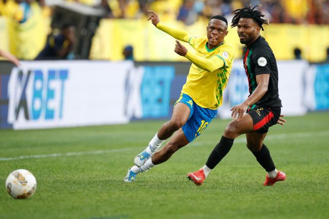 Sundowns' South African midfielder #16 Kutlwano Letlhaku and AS FAR's Angolan defender #2 To Carneiro eye the ball during the CAF Champions League final first leg football match between Mamelodi Sundowns and AS FAR (Association Sportive des Forces Armees Royales - Royal Army Club) at Loftus Versfeld Stadium in Pretoria on May 17, 2026. (Photo by Phill Magakoe / AFP)