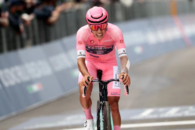 Bahrain - Victorious Portuguese rider Afonso Eulalio, wearing the overall leader's pink jersey (Maglia Rosa), crosses the finish line at the end of the 9th stage of the Giro d'Italia 2026 - Tour of Italy cycling race between Cervia and Corno alle Scale, near Doganaccia, central Italy on May 17, 2026. (Photo by Luca Bettini / AFP)