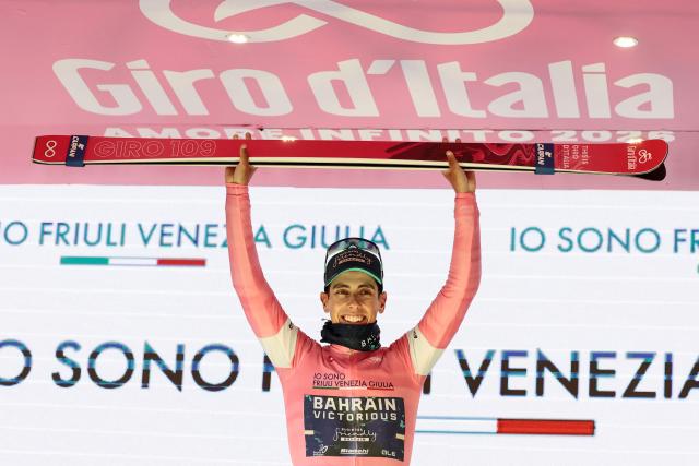 Bahrain - Victorious Portuguese rider Afonso Eulalio, wearing the overall leader's pink jersey (Maglia Rosa), celebrates on the podium for the 9th stage of the Giro d'Italia 2026 - Tour of Italy cycling race between Cervia and Corno alle Scale, near Doganaccia, central Italy on May 17, 2026. (Photo by Luca Bettini / AFP)