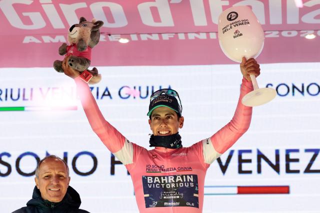 Bahrain - Victorious Portuguese rider Afonso Eulalio, wearing the overall leader's pink jersey (Maglia Rosa), celebrates on the podium for the 9th stage of the Giro d'Italia 2026 - Tour of Italy cycling race between Cervia and Corno alle Scale, near Doganaccia, central Italy on May 17, 2026. (Photo by Luca Bettini / AFP)