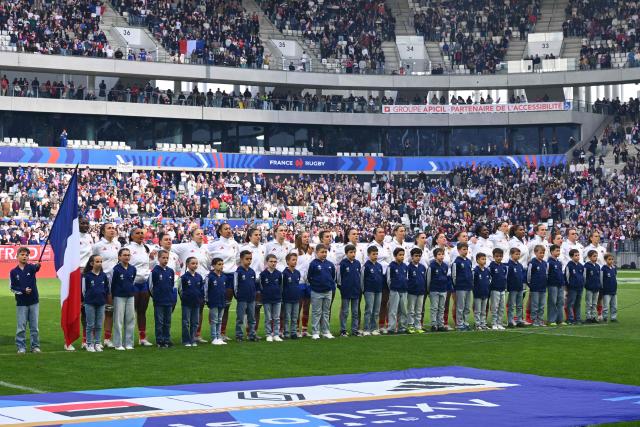 France's players stand alongside their mascots for the national anthems ahead of the Women's Six Nations international rugby union match between France and England at the Stade Atlantique in Bordeaux on May 17, 2026. (Photo by GAIZKA IROZ / AFP)