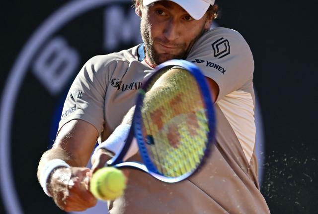 Norway's Casper Ruud hits a return to Italy's Jannik Sinner during the men's final of the ATP Rome Open tennis tournament at Foro Italico in Rome on May 17, 2026. (Photo by Filippo MONTEFORTE / AFP)