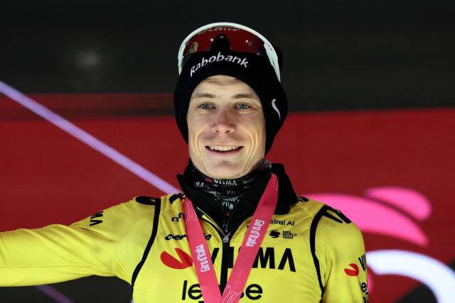 Team Visma Lease a Bike Danish rider Jonas Vingegaard, celebrates on the podium after winning the 9th stage of the Giro d'Italia 2026 - Tour of Italy cycling race between Cervia and Corno alle Scale, near Doganaccia, central Italy on May 17, 2026. (Photo by Luca Bettini / AFP)