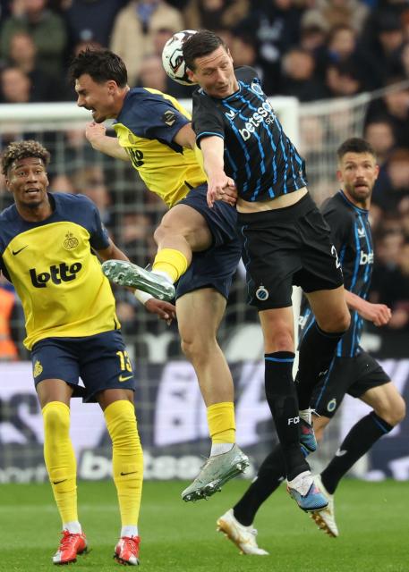 Royale Union Saint-Gilloise's German forward #09 Mateo Biondic (top c) and Club Brugge's Belgian midfielder #20 Hans Vanaken fight for the ball during the Belgian "Pro League" First Division football match between Club Brugge KV and Union Saint-Gilloise (USG - Saint Gilles) at the Jan Breydel Stadium in Bruges on May 17, 2026. (Photo by VIRGINIE LEFOUR / BELGA / AFP) / Belgium OUT