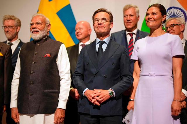 (First row) Indian Prime Minister Narendra Modi (L), Sweden's Prime Minister Ulf Kristersson (C), Sweden's Crown Princess Victoria (L) and other leaders (second row) pose for a family photo at the 'World of Volvo' Center in Gothenburg, Sweden, on May 17, 2026, for bilateral meetings with European business leaders on innovation and trade. (Photo by Bjorn LARSSON ROSVALL / TT NEWS AGENCY / AFP) / Sweden OUT