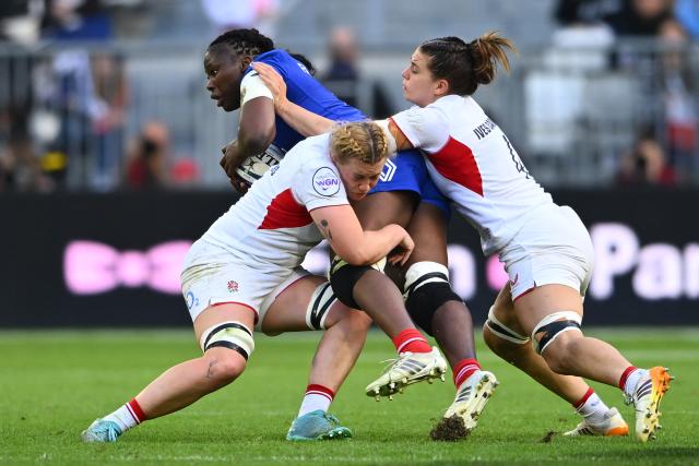 France's second row Madoussou Fall Raclot (C) is tackled by England's second row Delaney Burns (L) and England's second row Lilli Ives Campion (R) during the Women's Six Nations international rugby union match between France and England at the Stade Atlantique in Bordeaux on May 17, 2026. (Photo by GAIZKA IROZ / AFP)
