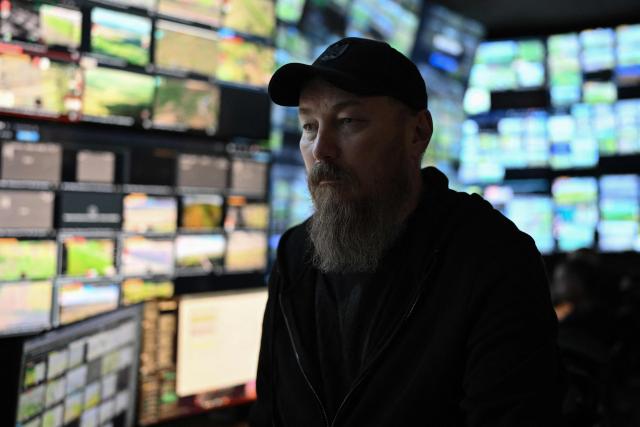 This photograph taken earlier in May 2026 and published on May 17, 2026, shows the Commander of Ukraine's Unmanned Forces, Robert Brovdi, known as "Madyar", during an interview with AFP in a command post at an undisclosed location in Ukraine, amid the Russian invasion of Ukraine. From his underground post, the commander of Ukraine's unmanned forces, Robert Brovdi, known as "Madyar", has been meticulously planning increasingly frequent strikes deep into Russian territory, which he sees as retribution for Russia's invasion. (Photo by Genya SAVILOV / AFP)