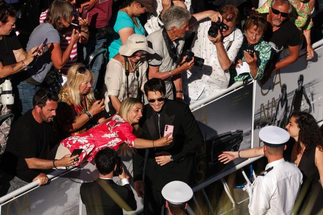 French actor Francois Civil signs autographs and poses for selfies with fans as he arrives for the screening of the film "Garance" (Another Day) at the 79th edition of the Cannes Film Festival in Cannes, southern France on May 17, 2026. (Photo by Sameer AL-DOUMY / AFP)