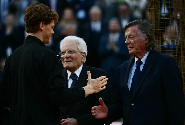 Italy's Jannik Sinner is congratulated by Italian former tennis player Adriano Panatta (R) and by Italian president Sergio Mattarella after winning the APT Rome Open tennis tournament final against Norway's Casper Ruud at the Foro Italico in Rome on May 17, 2026. (Photo by Filippo MONTEFORTE / AFP)