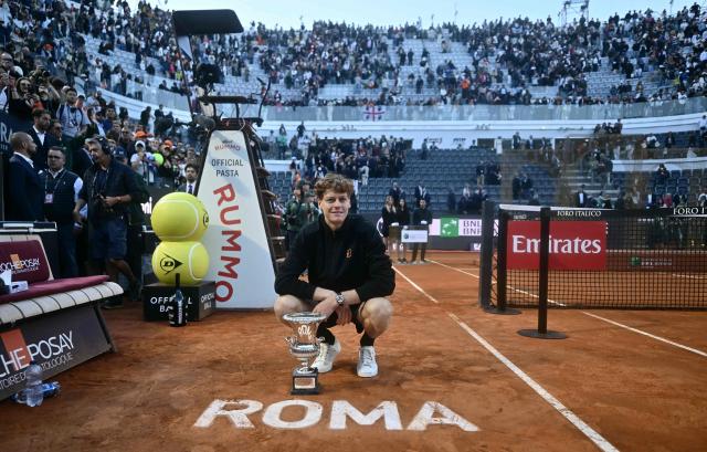 Italy's Jannik Sinner poses with the trophy after winning the men's final of the ATP Rome Open tennis tournament against Norway's Casper Ruud at the Foro Italico in Rome on May 17, 2026. (Photo by Filippo MONTEFORTE / AFP)