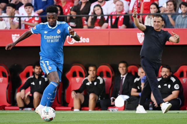 Sevilla's Spanish coach Luis Garcia reacts as Real Madrid's Brazilian forward #07 Vinicius Junior controls the ball during the Spanish league football match between Sevilla FC and Real Madrid CF at the Sanchez Pizjuan stadium in Seville on May 17, 2026. (Photo by CRISTINA QUICLER / AFP)