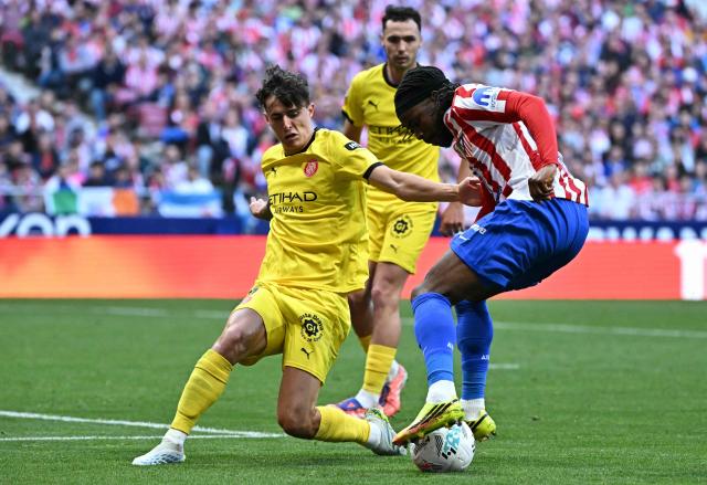 Girona's Spanish defender #16 Alejandro Frances (L) and Atletico Madrid's English forward #22 Ademola Lookman fight for the ball during the Spanish league football match between Club Atletico de Madrid and Girona FC at the Metroplitano stadium in Madrid on May 17, 2026. (Photo by Javier SORIANO / AFP)