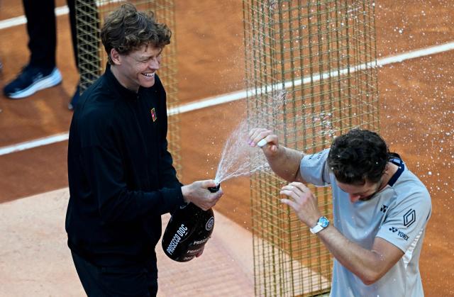 Italy's Jannik Sinner (L) celebrates with Norway's Casper Ruud, after winning the men's final of the ATP Rome Open tennis tournament at the Foro Italico in Rome on May 17, 2026. (Photo by Tiziana FABI / AFP)