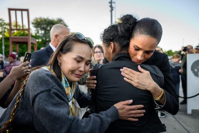 Duchess of Sussex, Britain's Meghan (R) reacts with people after attending the opening of the the “Lost Screen Memorial”, an art installation of giant illuminated smartphones representing 50 children who tragically lost their lives following harm linked to social media, displayed at Place des Nations, ahead of the 79th World Health Assembly in Geneva, on May 17, 2026. (Photo by Fabrice COFFRINI / AFP)