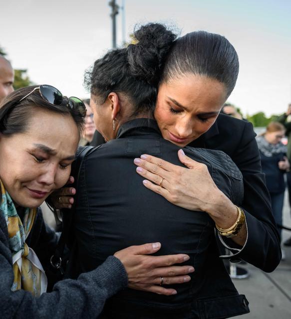 Duchess of Sussex, Britain's Meghan (R) reacts with people after attending the opening of the the “Lost Screen Memorial”, an art installation of giant illuminated smartphones representing 50 children who tragically lost their lives following harm linked to social media, displayed at Place des Nations, ahead of the 79th World Health Assembly in Geneva, on May 17, 2026. (Photo by Fabrice COFFRINI / AFP)