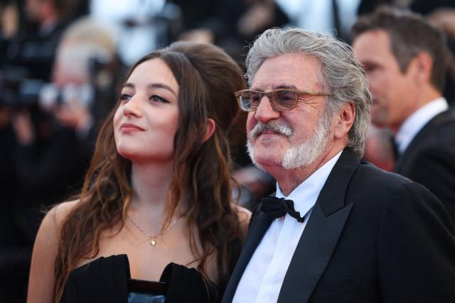 French actress Luana Bajrami  (L) and French actor and director Daniel Auteuil arrives for the screening of the film "La Troisieme Nuit" (When the Night Falls) at the 79th edition of the Cannes Film Festival in Cannes, southern France on May 17, 2026. (Photo by Valery HACHE / AFP)