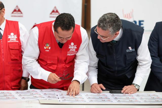 Peru's National Jury of Elections (JNE) president Roberto Burneo Bermejo (L) and the acting head of the National Office of Electoral Processes (ONPE), Bernardo Pachas, inspect ballot papers for the second round of the presidential election after their printing at Pacifico Editores SAC in Lima on May 17, 2026. Right-wing candidate Keiko Fujimori and left-wing candidate Roberto Sanchez will face off on June 7 in Peru's presidential runoff, the electoral authority confirmed on May 17 when it officially proclaimed the results. (Photo by Connie FRANCE / AFP)