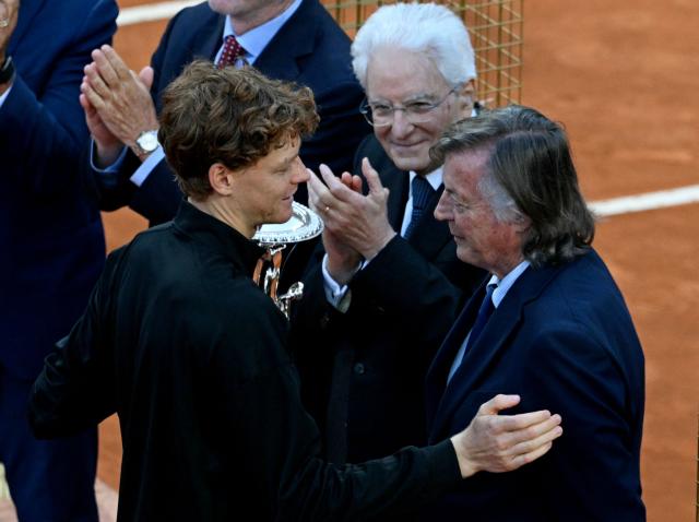 Italy's Jannik Sinner is congratulated by Italian former tennis player Adriano Panatta and Italian president Sergio Mattarella, after winning the APT Rome Open tennis tournament final against Norway's Casper Ruud at the Foro Italico in Rome on May 17, 2026. (Photo by Tiziana FABI / AFP)
