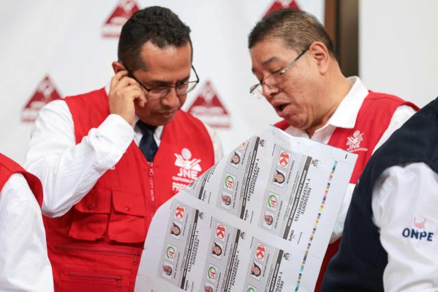 Peru's National Jury of Elections (JNE) president Roberto Burneo Bermejo (L) inspects ballot papers for the second round of the presidential election after their printing at Pacifico Editores SAC in Lima on May 17, 2026. Right-wing candidate Keiko Fujimori and left-wing candidate Roberto Sanchez will face off on June 7 in Peru's presidential runoff, the electoral authority confirmed on May 17 when it officially proclaimed the results. (Photo by Connie FRANCE / AFP)