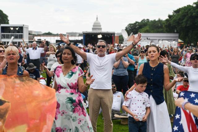 Attendees pray and celebrate during "Rededicate 250: A National Jubilee of Prayer, Praise and Thanksgiving" on the National Mall in Washington, DC, on May 17, 2026. (Photo by Matthew Hatcher / AFP)