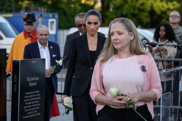 (From L) Mayor of Geneva Alfonso Gomez, World Health Organization (WHO) Director-General Tedros Adhanom Ghebreyesus Duchess of Sussex, Britain's Meghan and Amy Neville, mother of late Alexander hold a white rose during the opening of the “Lost Screen Memorial”, an art installation of giant illuminated smartphones representing 50 children who tragically lost their lives following harm linked to social media, displayed at Place des Nations, ahead of the 79th World Health Assembly in Geneva, on May 17, 2026. (Photo by Fabrice COFFRINI / AFP)