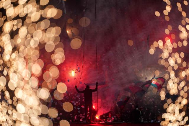 TOPSHOT - Paris Saint-Germain's supporters celebrate winning the French Ligue 1 football championship in the stands ahead of the French L1 football match between Paris FC and Paris Saint-Germain (PSG) at the Stade Jean-Bouin in Paris on May 17, 2026. (Photo by Dimitar DILKOFF / AFP)