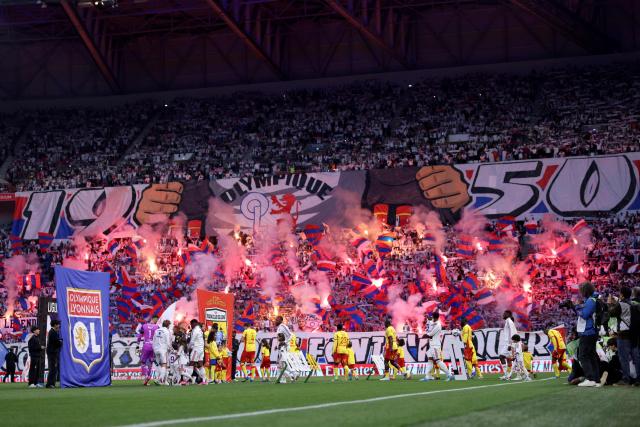 Lyon’s supporters aka "Lyon 1950 - Virage Sud" cheer as teams enter the pitch for the French L1 football match between Olympique Lyonnais (OL) and RC Lens at the Groupama Stadium in Decines-Charpieu, central-eastern France, on May 17, 2026. (Photo by Alex MARTIN / AFP)