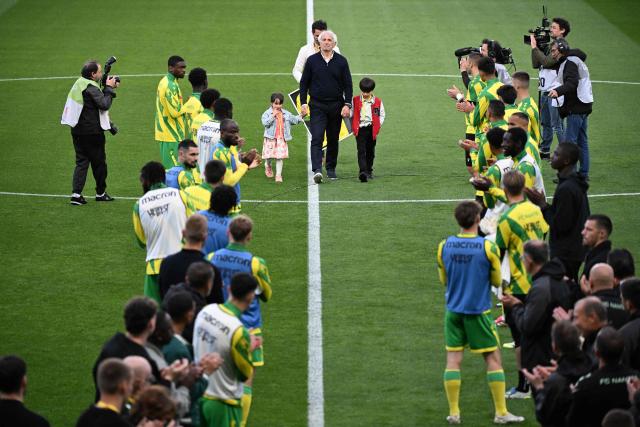 Nantes' Bosnian head coach Vahid Halilhodzic (C) attends a career tribute ceremony ahead of the French L1 football match between FC Nantes and Toulouse FC at the Stade de la Beaujoire–Louis Fonteneau in Nantes, western France, on May 17, 2026. (Photo by Sebastien Salom-Gomis / AFP)