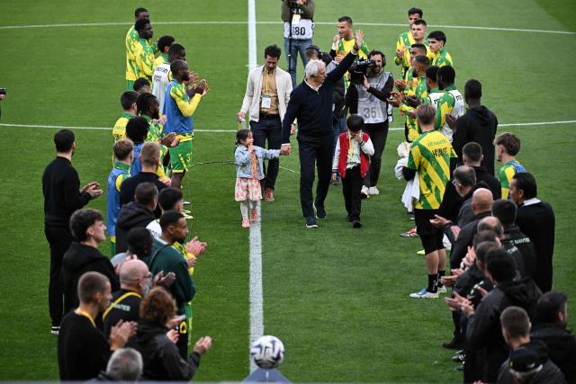 Nantes' Bosnian head coach Vahid Halilhodzic (C) attends a career tribute ceremony ahead of the French L1 football match between FC Nantes and Toulouse FC at the Stade de la Beaujoire–Louis Fonteneau in Nantes, western France, on May 17, 2026. (Photo by Sebastien Salom-Gomis / AFP)