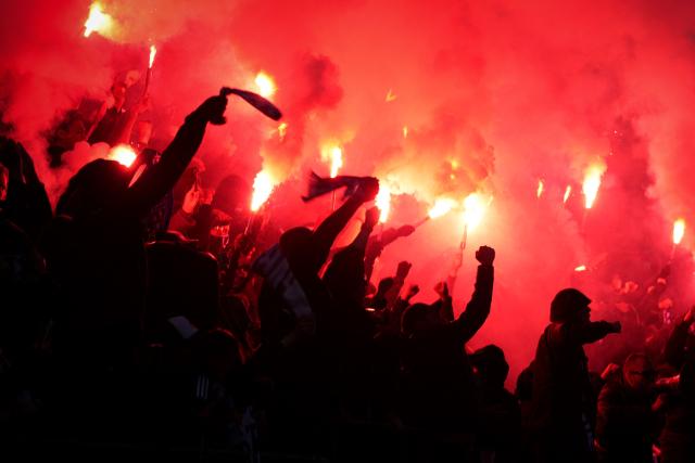 Paris FC's supporters light flares as they cheer their team on from the stands during the French L1 football match between Paris FC and Paris Saint-Germain (PSG) at the Stade Jean-Bouin in Paris on May 17, 2026. (Photo by Dimitar DILKOFF / AFP)