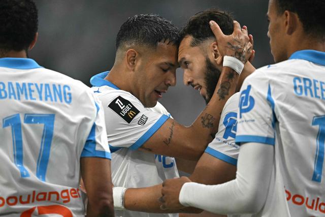 Marseille's Algerian forward #09 Amine Gouiri (Centre R) celebrates scoring his team's second goal during the French L1 football match between Olympique de Marseille (OM) and Stade Rennais FC at the Stade Velodrome in Marseille, southern France, on May 17, 2026. (Photo by Gabriel BOUYS / AFP)