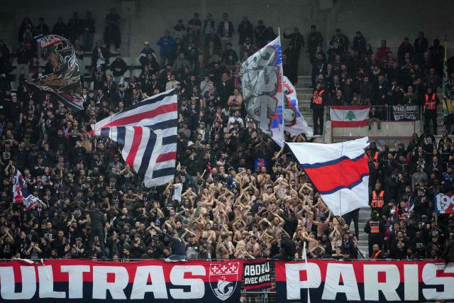 Paris Saint-Germain's supporters cheer their team on from the stands ahead of the French L1 football match between Paris FC and Paris Saint-Germain (PSG) at the Stade Jean-Bouin in Paris on May 17, 2026. (Photo by Dimitar DILKOFF / AFP)