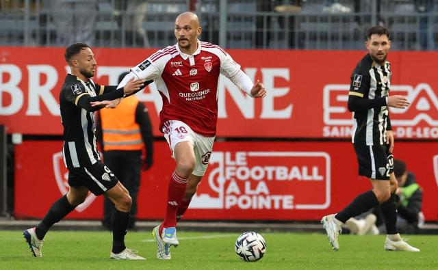Brest's French forward #19 Ludovic Ajorque (C) fights for the ball with Angers' Algerian midfielder #93 Haris Belkebla during the French L1 football match between Stade Brestois 29 (Brest) and SCO Angers at the Stade Francis-Le-Ble in Brest, western France, on May 17, 2026. (Photo by Fred TANNEAU / AFP)