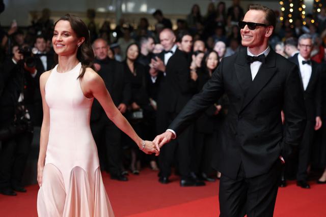Swedish actress Alicia Vikander and German actor Michael Fassbender arrive for the screening of the film "Hope" at the 79th edition of the Cannes Film Festival in Cannes, southern France on May 17, 2026. (Photo by Valery HACHE / AFP)
