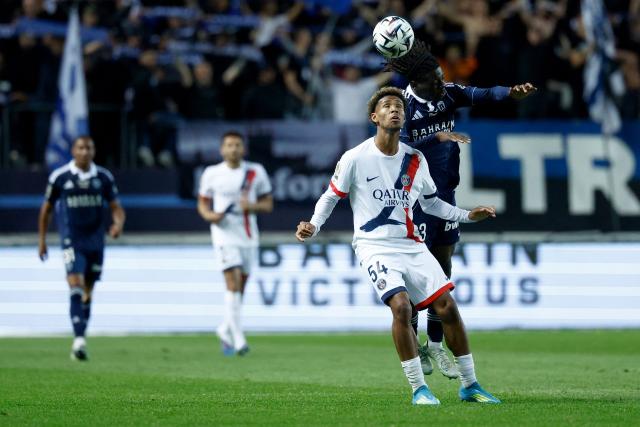 Paris FC's French midfielder #23 Rudy Matondo (R) and Paris Saint-Germain's French defender #54 Dimitri Lucea (2R) fight for the ball in the air during the French L1 football match between Paris FC and Paris Saint-Germain (PSG) at the Stade Jean-Bouin in Paris on May 17, 2026. (Photo by Kenzo TRIBOUILLARD / AFP)